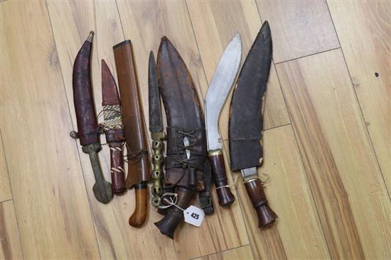 Three kukris, a kris and other daggers or knives, longest item 41cm